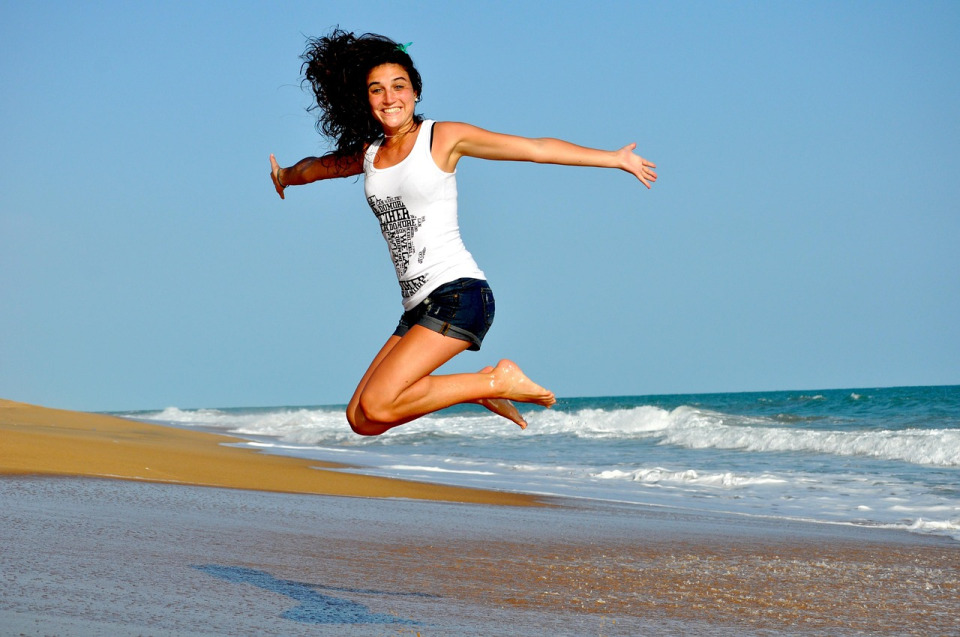 Female contractor smiling and jumping in the air